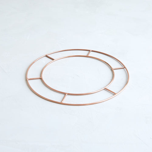 Our elegant 8" wreath form is fashioned from sturdy copper. Two concentric hoops make building the perfect seasonal wreath simple. Cover the entire form or take a minimal approach, leaving a stretch of brilliant copper revealed. Reusable season after season, year after year.