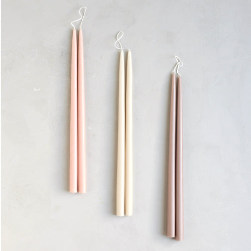 Our Canyon Dipped Taper Set combines our three best selling hues into the perfect bundle. Display the colors together or separately.   Set includes: one pair of petal, parchment & greige 18" dipped taper candles.   Our tapers are crafted to burn drip-free at a rate of approximately 1 hour per inch. Each candle is dipped 35 times for a superior depth of color, and pairs are joined by a braided cotton wick for the cleanest burn.