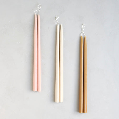 Our Apiary Dipped Taper Set combines our three best selling hues into the perfect bundle. Display the colors together or separately. Made of high grade paraffin wax in the United States.   Set includes: one pair of petal, parchment & miel 18" dipped taper candles. 
