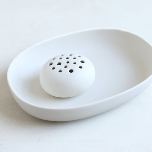 The ceramic oval dish and flower frog set is the perfect pair to display nature in your home or on your table. The holes can be filled with water to display a minimal selection of flowers, or keep herbs fresh on your kitchen counter. When not in use, display it as a sculptural object. Food, Microwave, dishwasher and oven safe.
