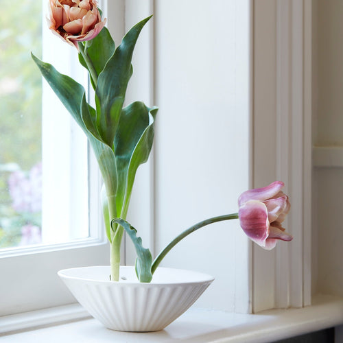White ceramic pleated flower frog vase
