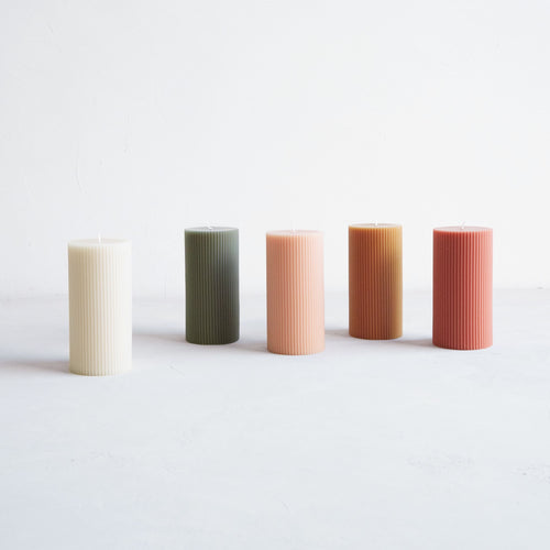 Our 3x6 ribbed pillar is a modern take on a traditional candle and embodies a superior depth of color, a cotton wick, and a 70-hour burn time. Subtle variations in wax depth and color opacity may occur. Available in 5 custom colors: Parchment, Moss, Petal, Miel, and Clay.
