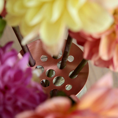 Our handcrafted Copper Flower Frogs are an aesthetically considered take on a utilitarian design mechanic. Used to space stems out and hold them in place, they pair perfectly with our Ceramic Cylinder Vase and the Ikebana Vase. Can also be used to secure your blooms in any home vase, mason jar or vessel.  Pure copper, they will patina gracefully over time.