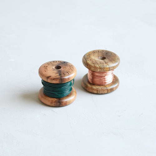 Our pliable, medium-gauge wire comes on pretty wooden spools, and can be used in creating all kinds of craft and floral projects. It's available in either shiny copper that will patina over time, or in a classic green that will blend with stems and leaves.   Dimensions: 24 gauge x 50ft.