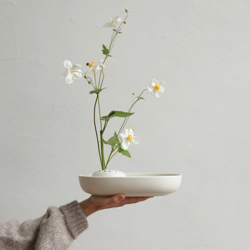Our stand-alone ceramic frog is perfectly paired with the oval dish. It can also be used independently or with any open vessel of your choosing. The holes can be filled with water to display a minimal selection of flowers, or keep herbs fresh on your kitchen counter. When not in use, display it as a sculptural object. 