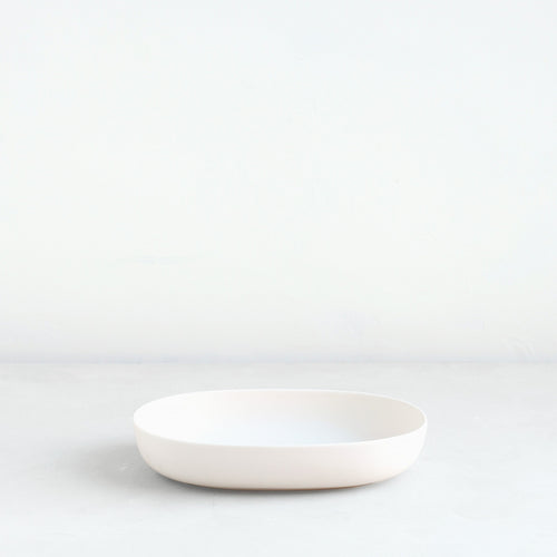 The oval dish is the perfect companion to the oval flower frog or a traditional pin frog. Designed to display a minimal selection of blooms, the oval dish can also be used as a catch-all tray, a fruit bowl or a serving platter. Smaller in scale but identical in form, the dish pairs perfectly with the “ceramic flower frog bowl & taper holder” for a seamless, sculptural tabletop. Food, Microwave, dishwasher and oven safe.