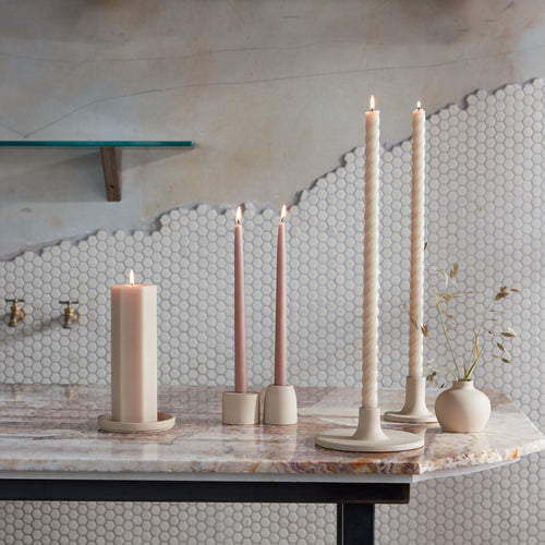 Our ceramic taper holders offer a fresh variation in shape and size and boast a clean, matte-speckled sand finish. With stand-alone appeal, they also feel dynamic as a collection. Each holder is sized to fit a standard taper candle.