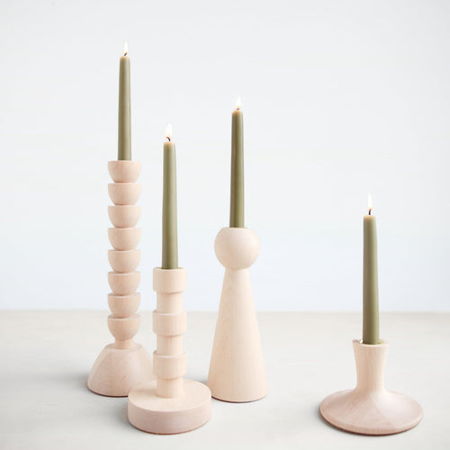 The Trumpet Candle Holder is hand turned in Lostine's small wood shop in Pennsylvania. This simple, modern design is made with map.  Each candle holder has a brass insert and pairs perfectly with our taper candles. Made in USA.