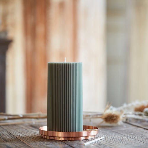 This copper pillar plate is the perfect companion to our fancy pillar candles. Its wide base provides a safe surface to burn pillar candles and the simplistic design proves to be an ideal accent piece to any space. Makes a great jewelry catchall too. Made of copper-plated iron and hand-finished—slight variations may occur.   Dimensions: 5” D